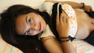 Petite Laos Teen lifts shirt to show tummy and bra