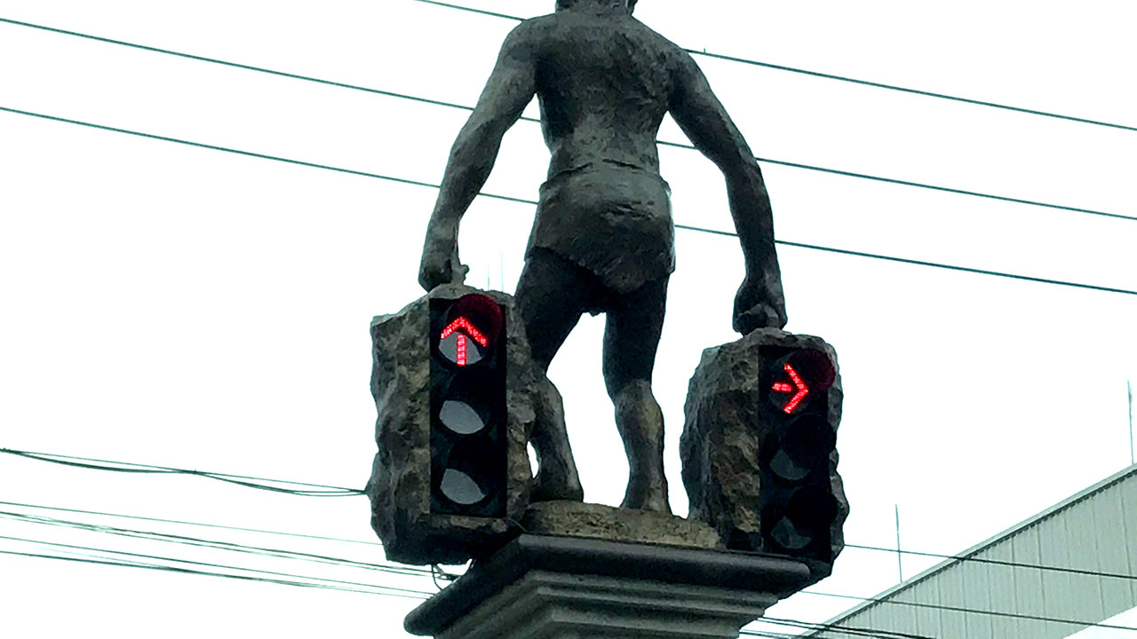 Street intersection lights with statue in Krabi Town, Thailand, upon my arrival