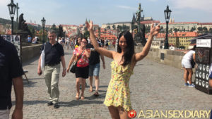 Tattooed Asian Slut poses in the streets