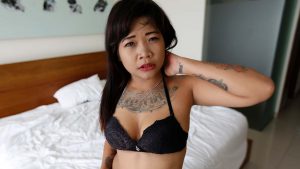 Chubby Tattooed Asian poses shy in bra