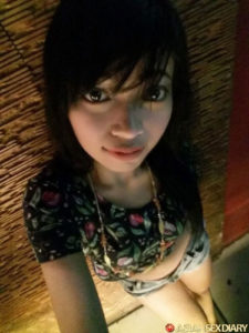 Taking her own picture is Asian selfie girl