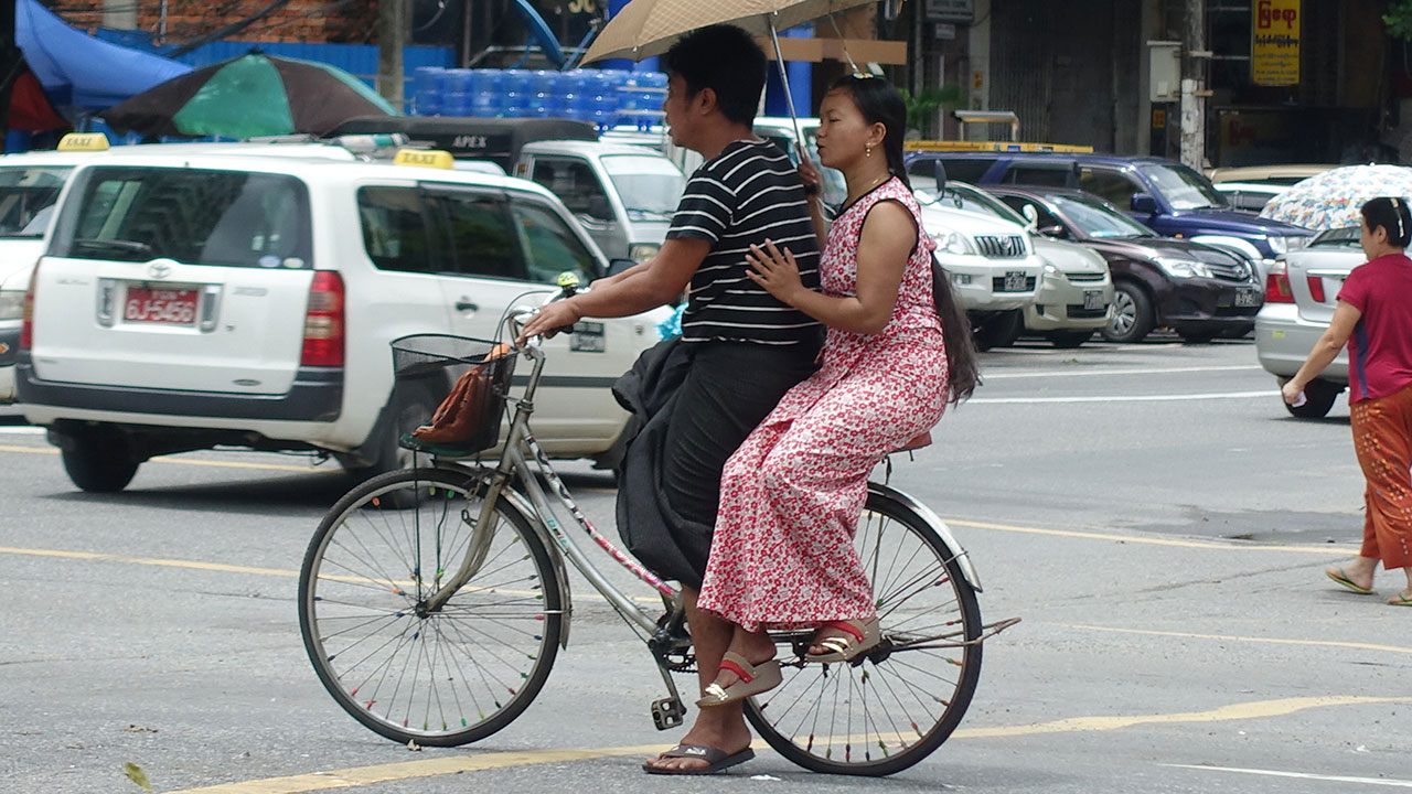 Myanmar Girls like this one in a dress on back of bike
