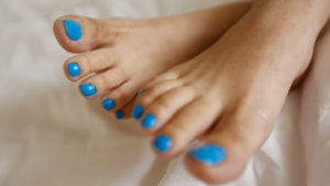 Asian Girl shows her painted blue toes