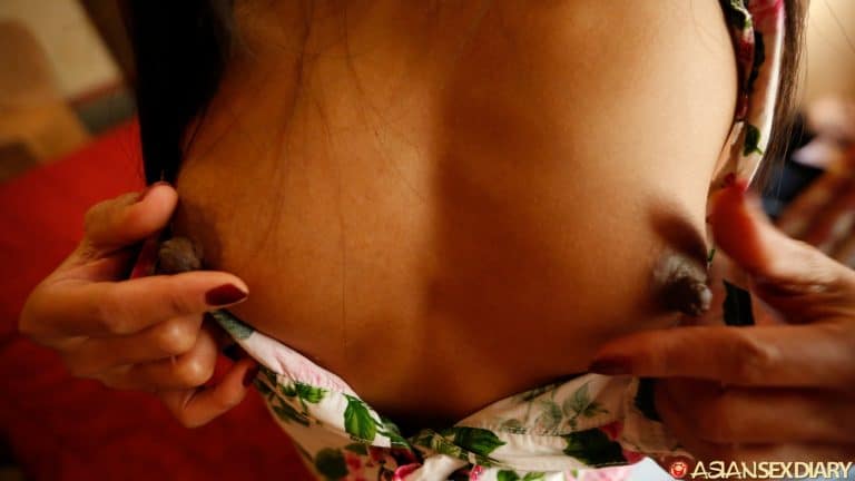 Pinching big dark nipples on small tits