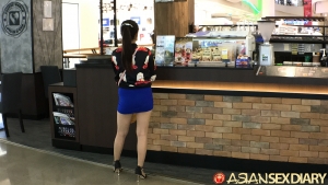 Cute Asian girl in short skirt at the mall after a car show