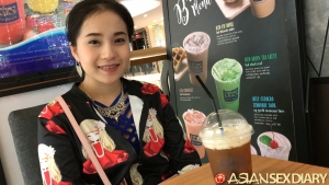 Cute Asian girl enjoys an iced tea