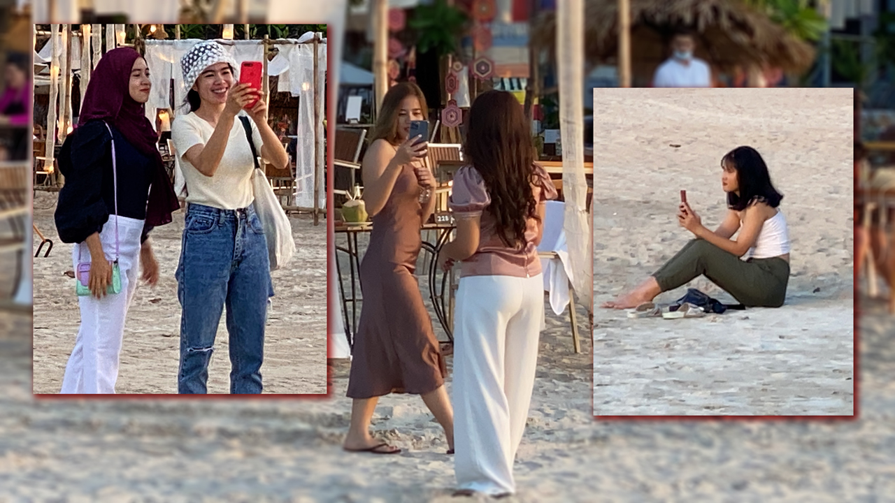 NN Beach girls taking pics with cell phones