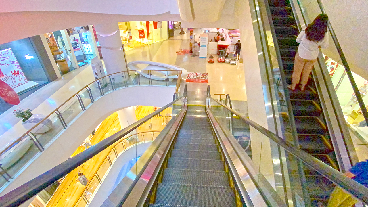 View of Bangkok girl on Thai Shopping Mall escalator