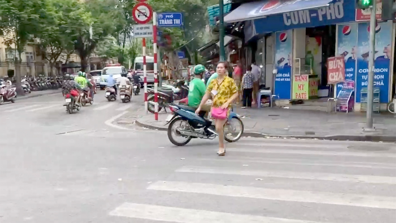 Grab App driver parked near crosswalk in Hanoi Vietnam