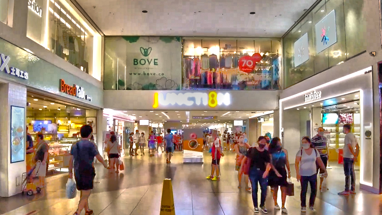 Singapore Covid era Mall customers walking in aisle all with Masks on