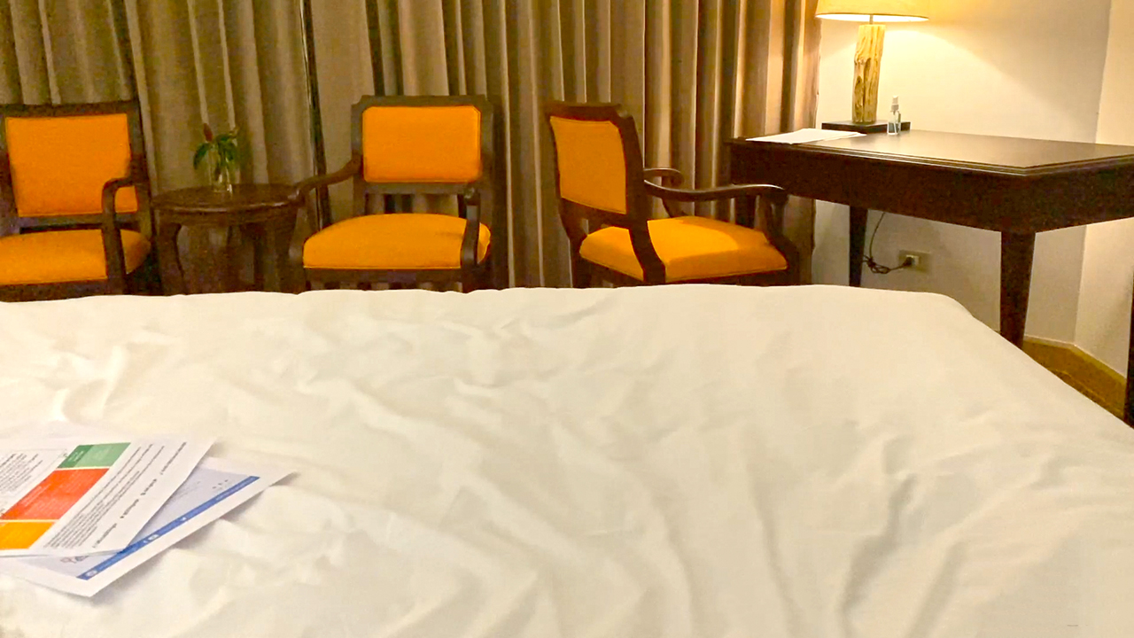 Sitting on bed in PHILIPPINES QUARANTINE room