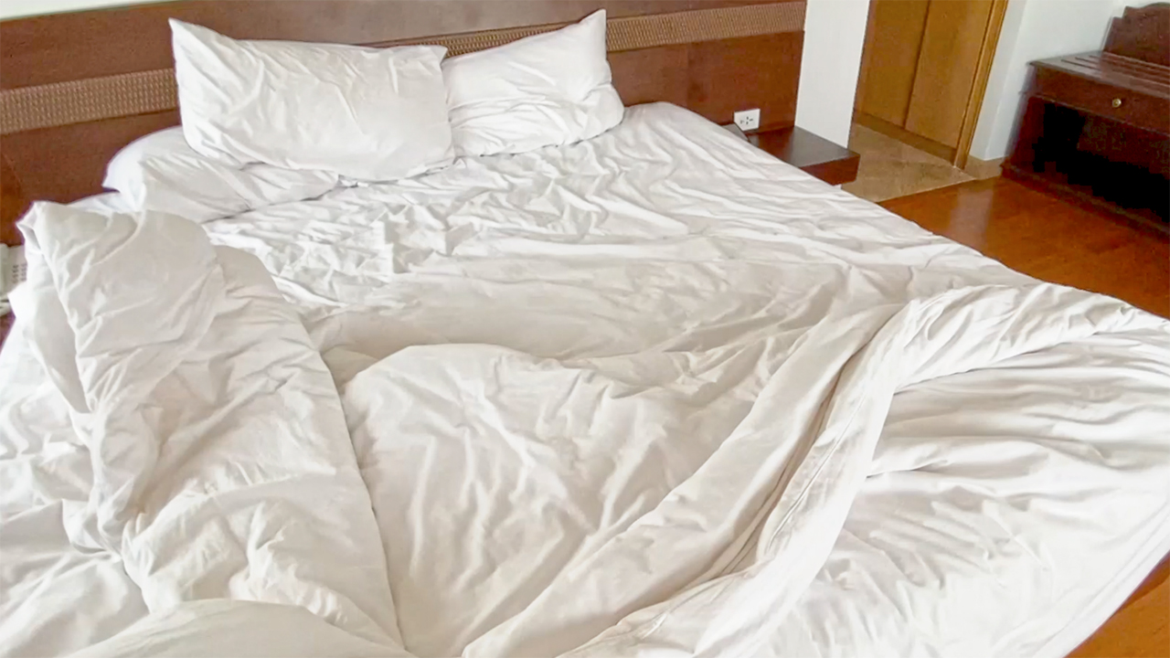 View of empty unmade hotel bed in day of my Negative Covid Test Result news