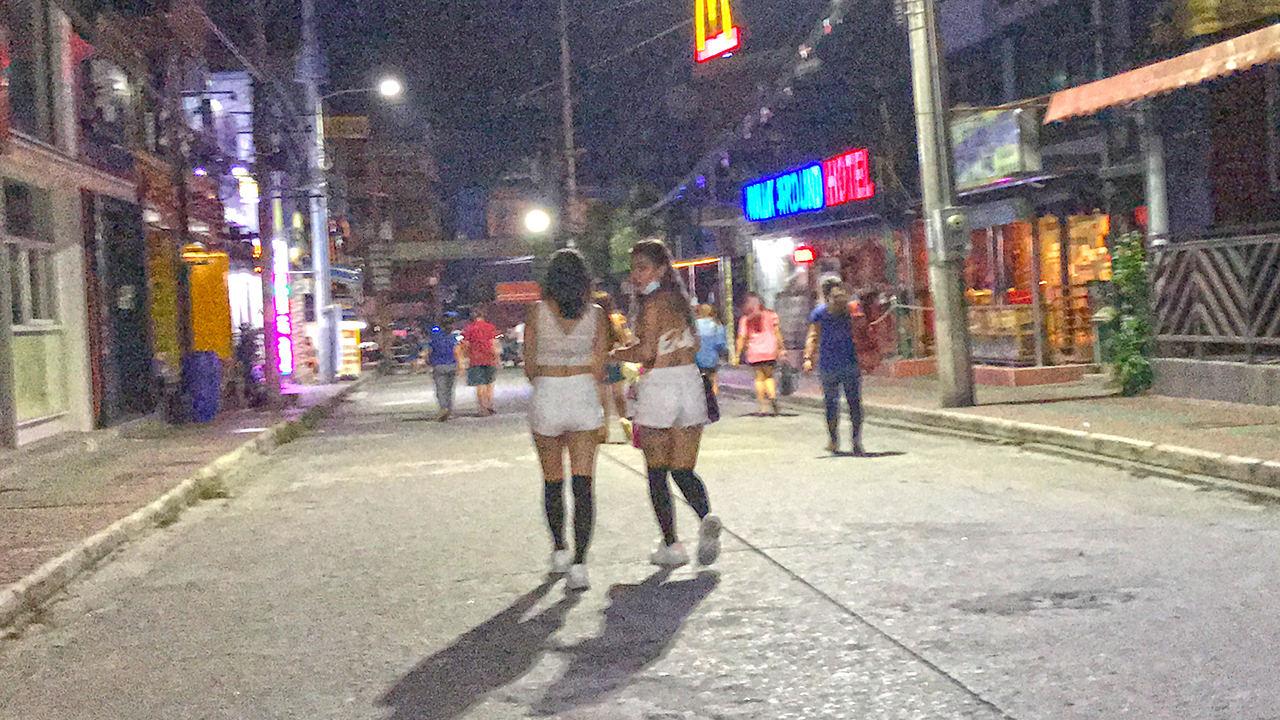 Two Filipina girls with Hot Ass In White Shorts walking up street at night