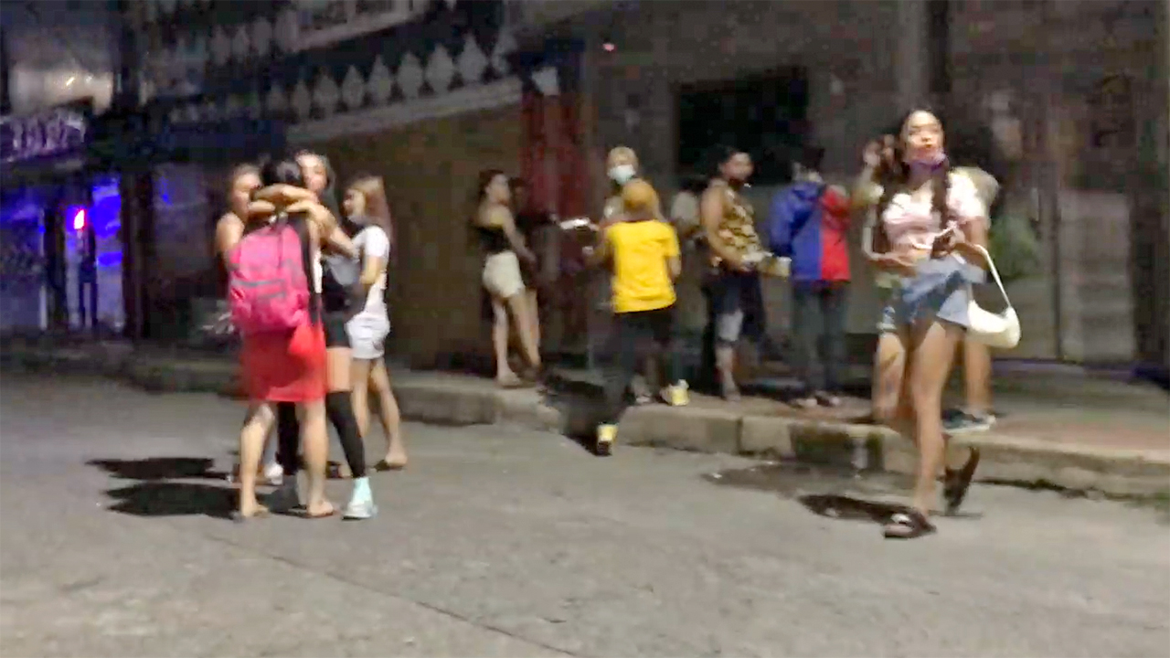 Slutty Party Girls talking and walking away from the clubs in Angeles City