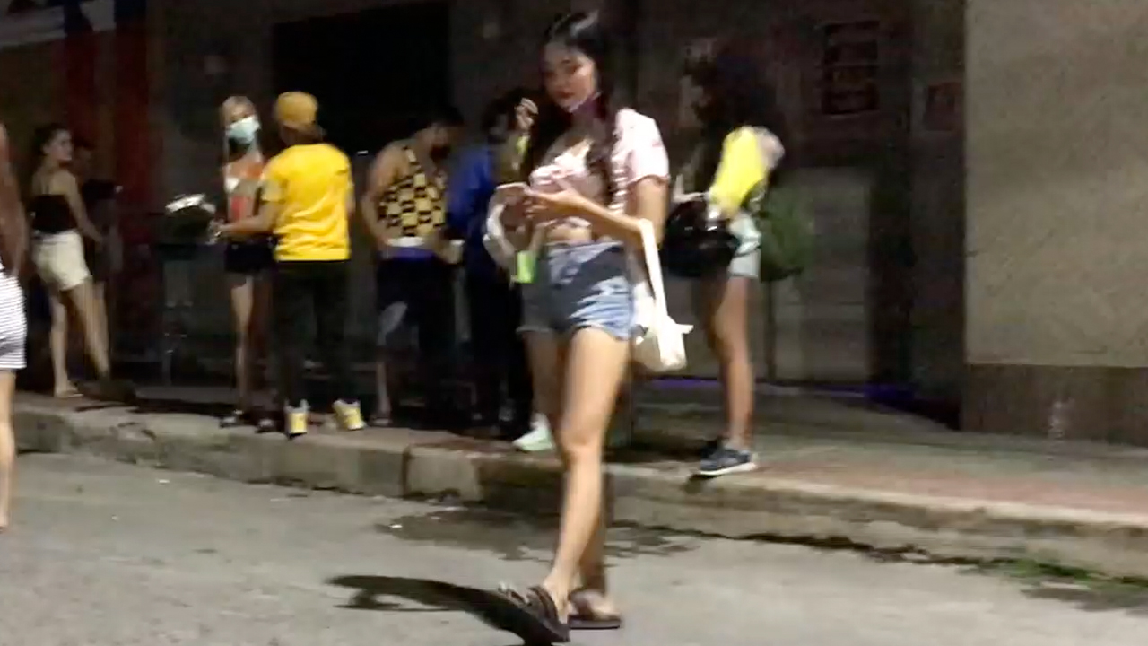 Girl with Sexy legs in Shorts walking while texting
