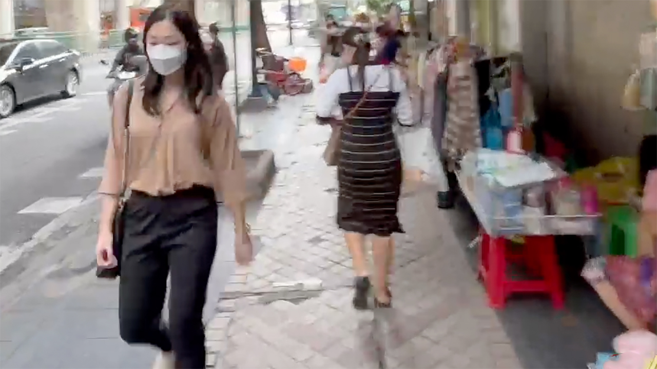 Sexy Business Women walking on sidewalk in Silom District of Bangkok