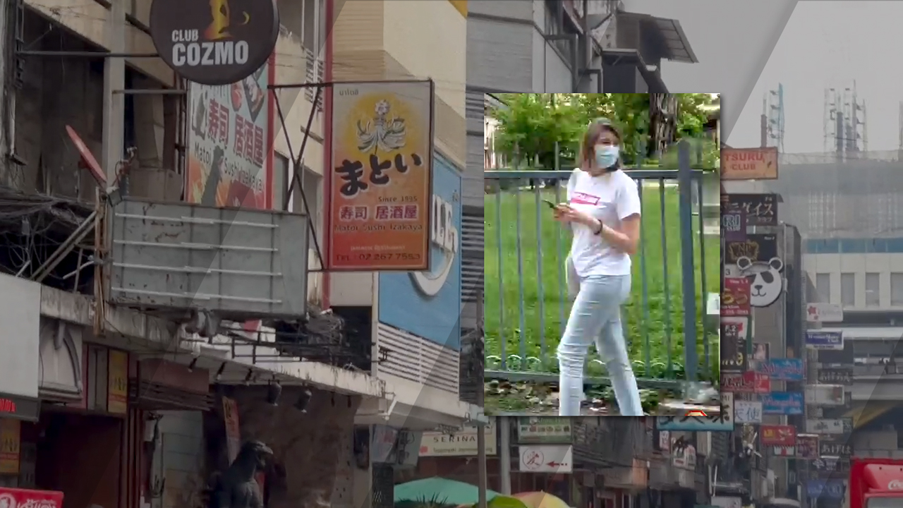 Asian Cutie In Jeans walks down the sidewalk while looking texting