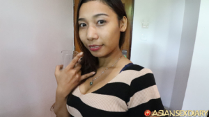 Beautiful exotic Thai teen drinking water