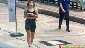 Cute tattooed teen walking down sidewalk