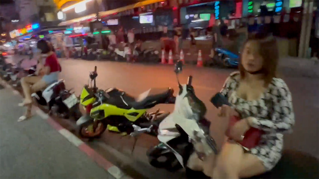 Thai babe sits on motorbike while living Life In Bangkok At Night