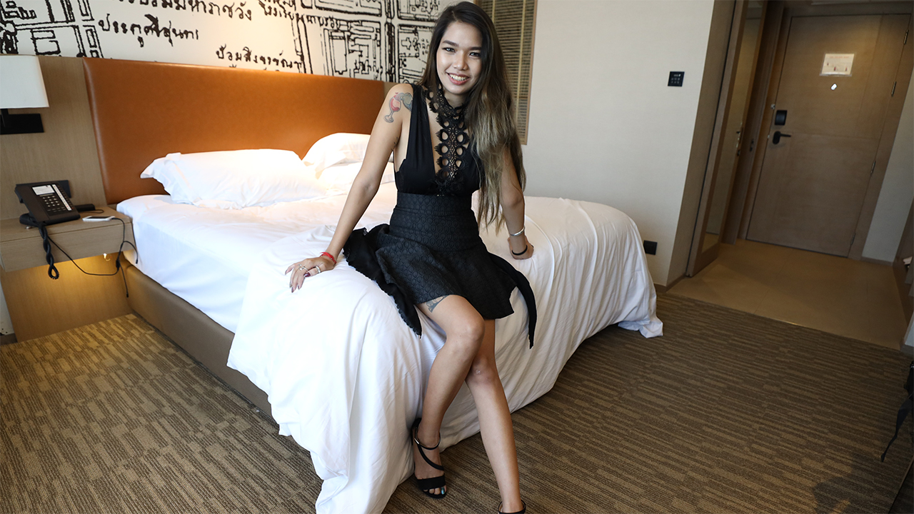 Sexy Thai Model Nori poses in black sexy dress on bed