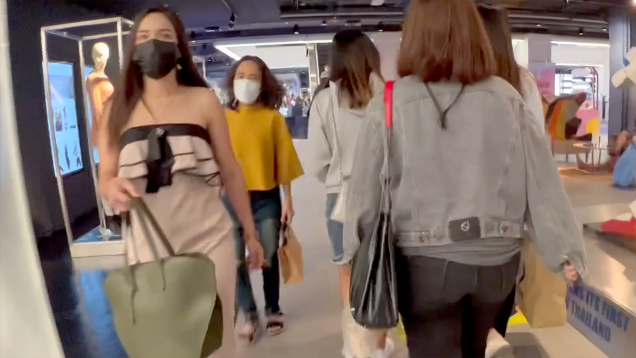 View of masked cute Thai girls doing Bangkok Christmas Shopping