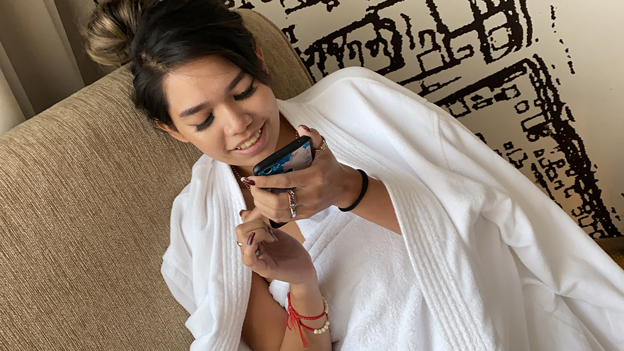 Cute Lazy Girl texting in bathrobe