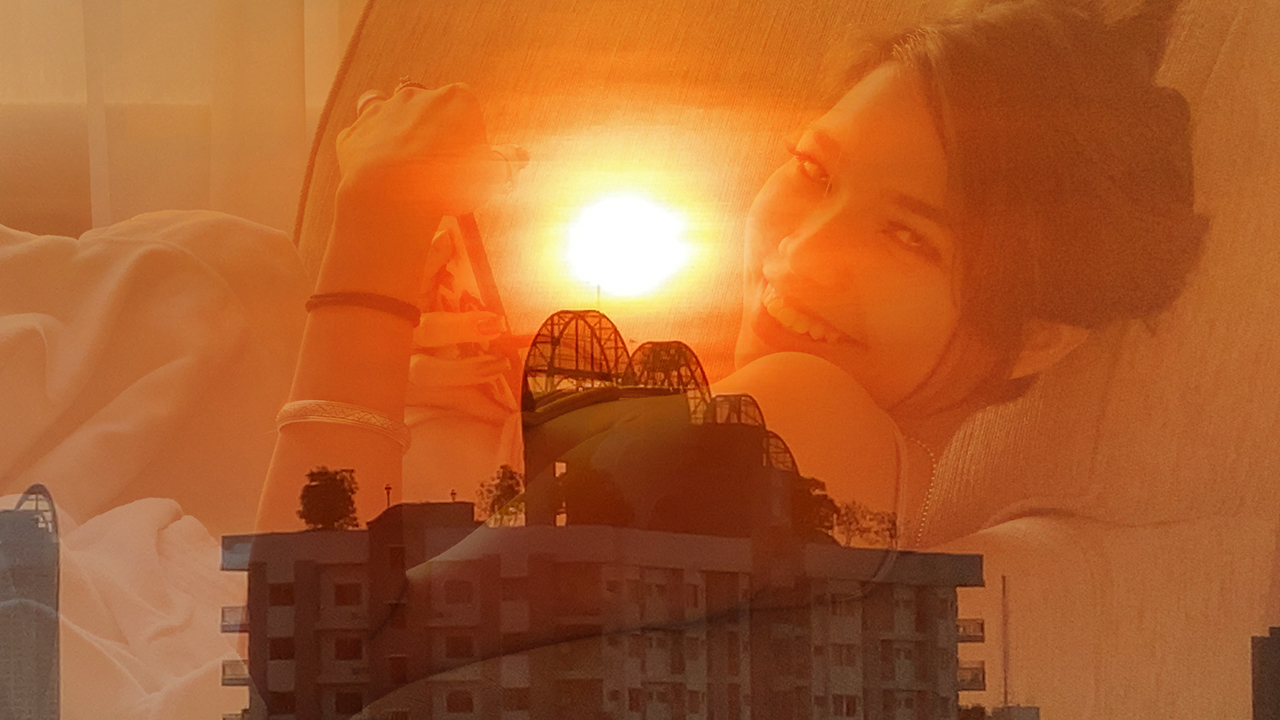 Thai model Nori relaxes in superimposed image of a Bangkok Sunset