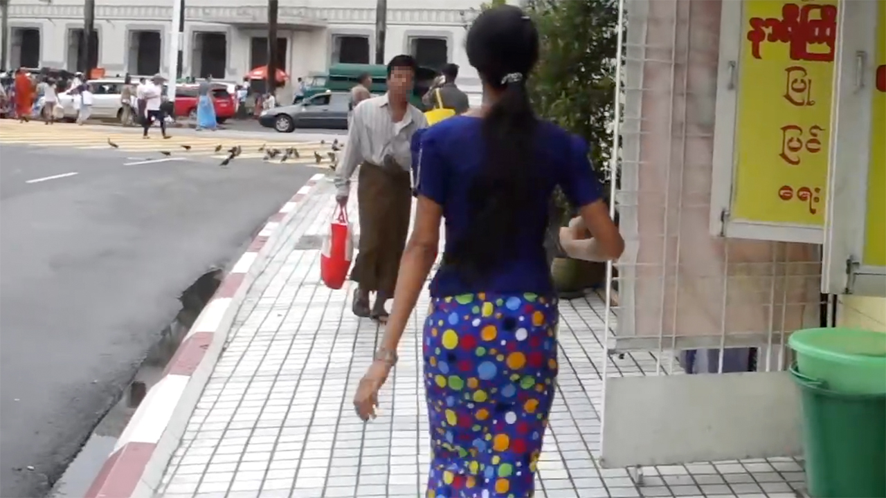 Cute Myanmar Girl wearing traditional dress on sidewalk