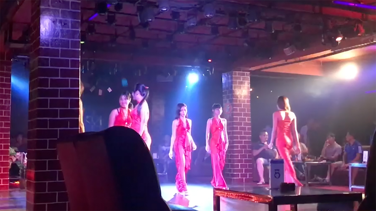 Emperor Disco Girls walk on stage in red outfits