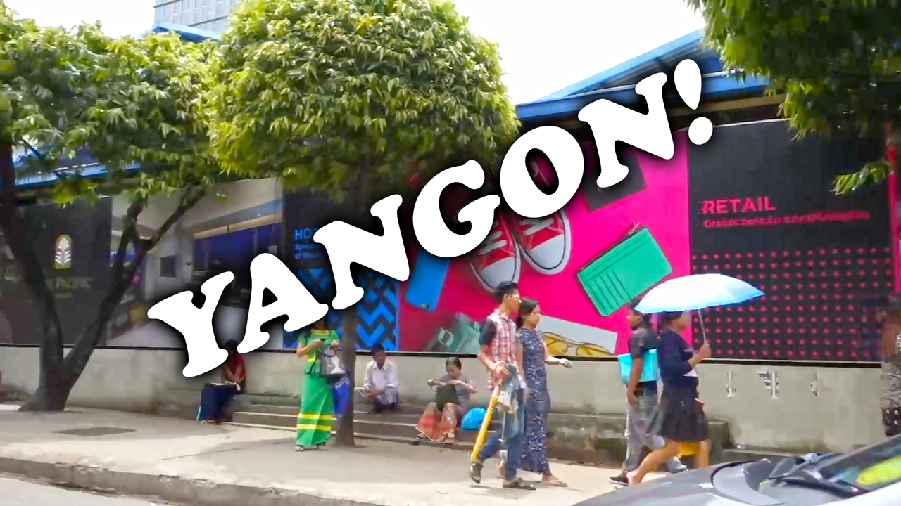 View of random Yangon Street with cute girls and locals