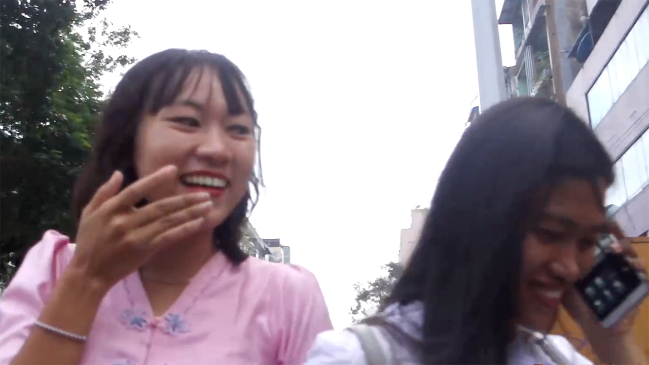 Fun Burmese Girls laughing and talking on phone