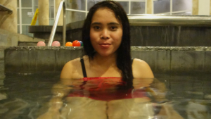 Mya sits in water at Yangon Bath House