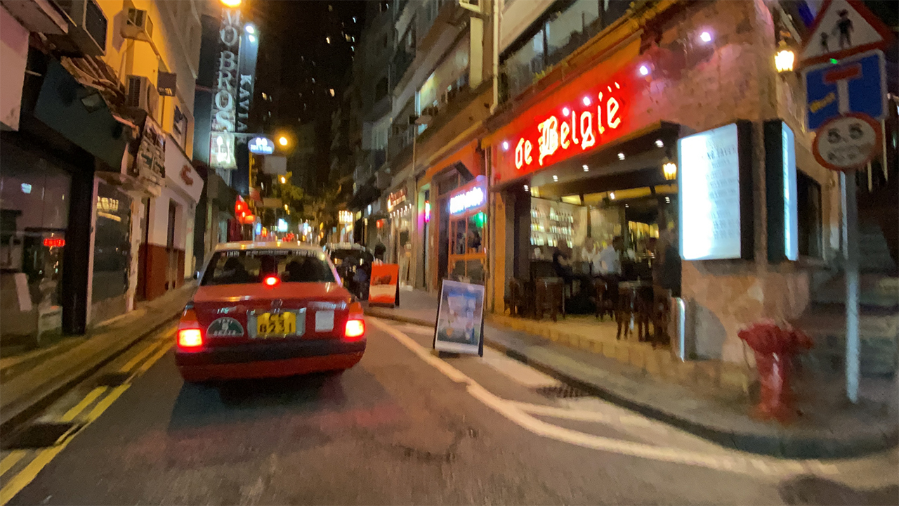 Taxi driving down street of Soho Hong Kong