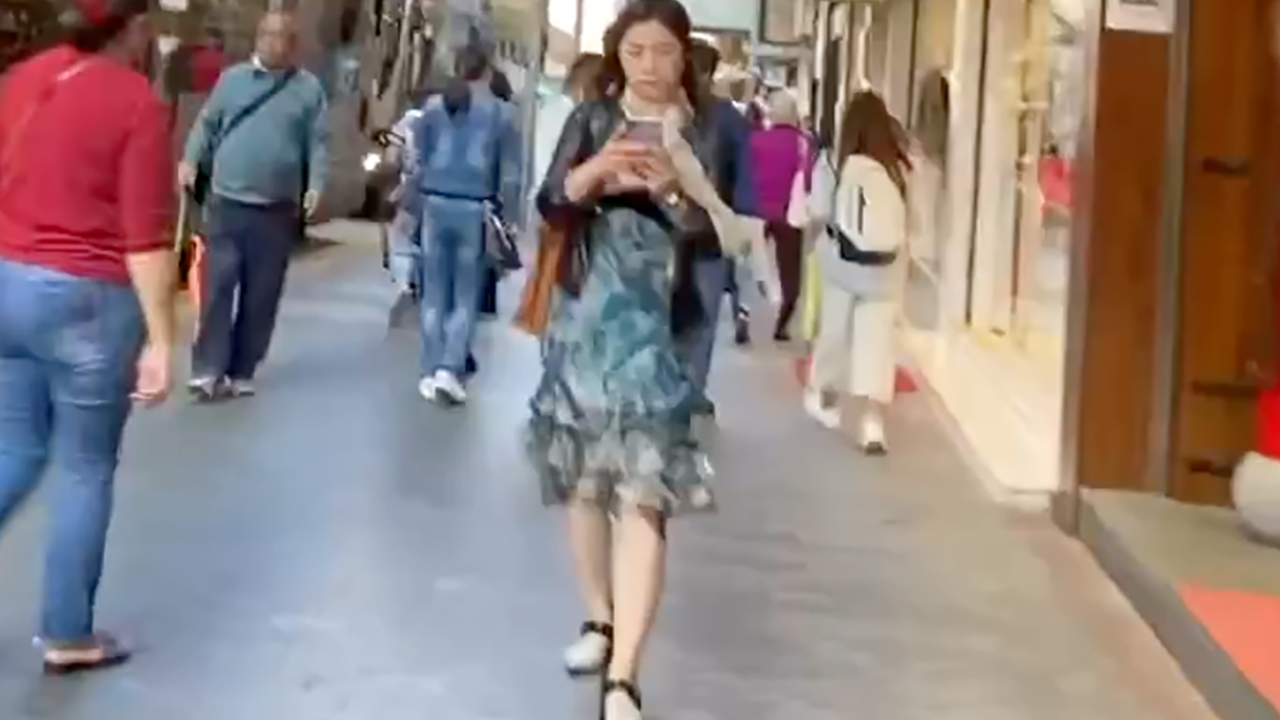 Hong Kong Girl Texting While Walking on sidewalk in heels