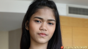 Shy nervous Thai teen smiles for camera