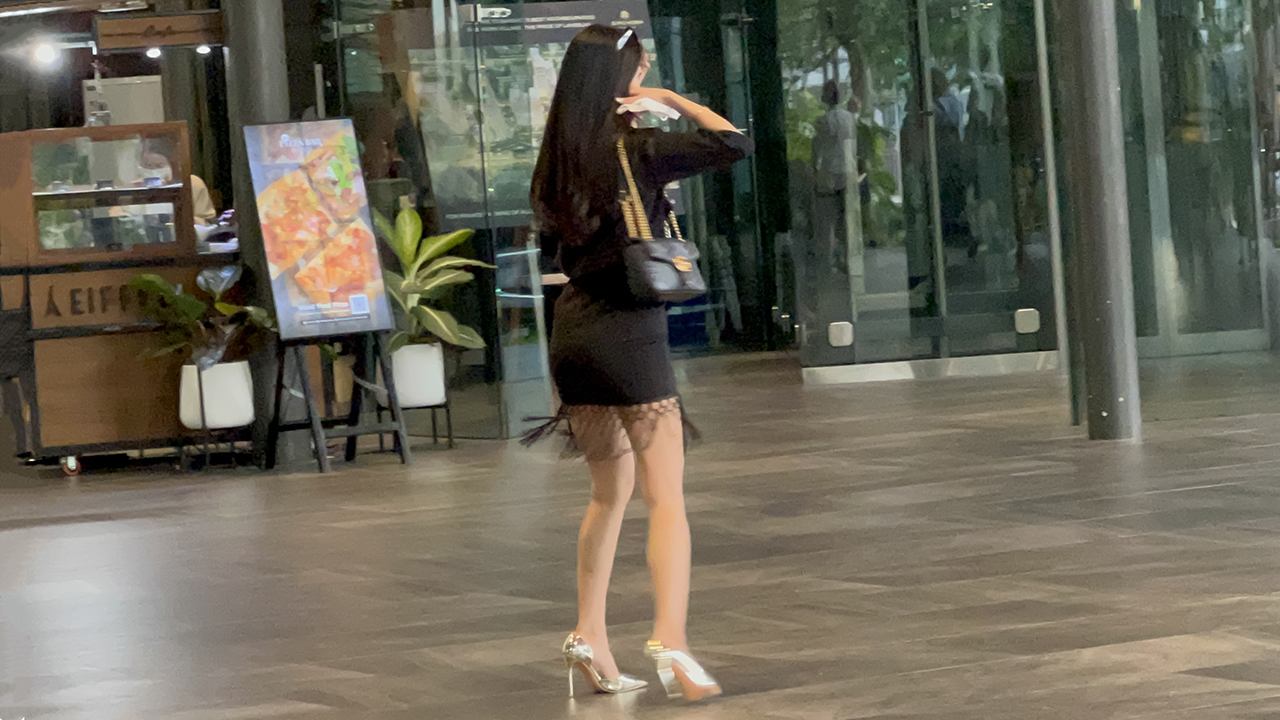 Short Skirt Asian poses in mall for photo