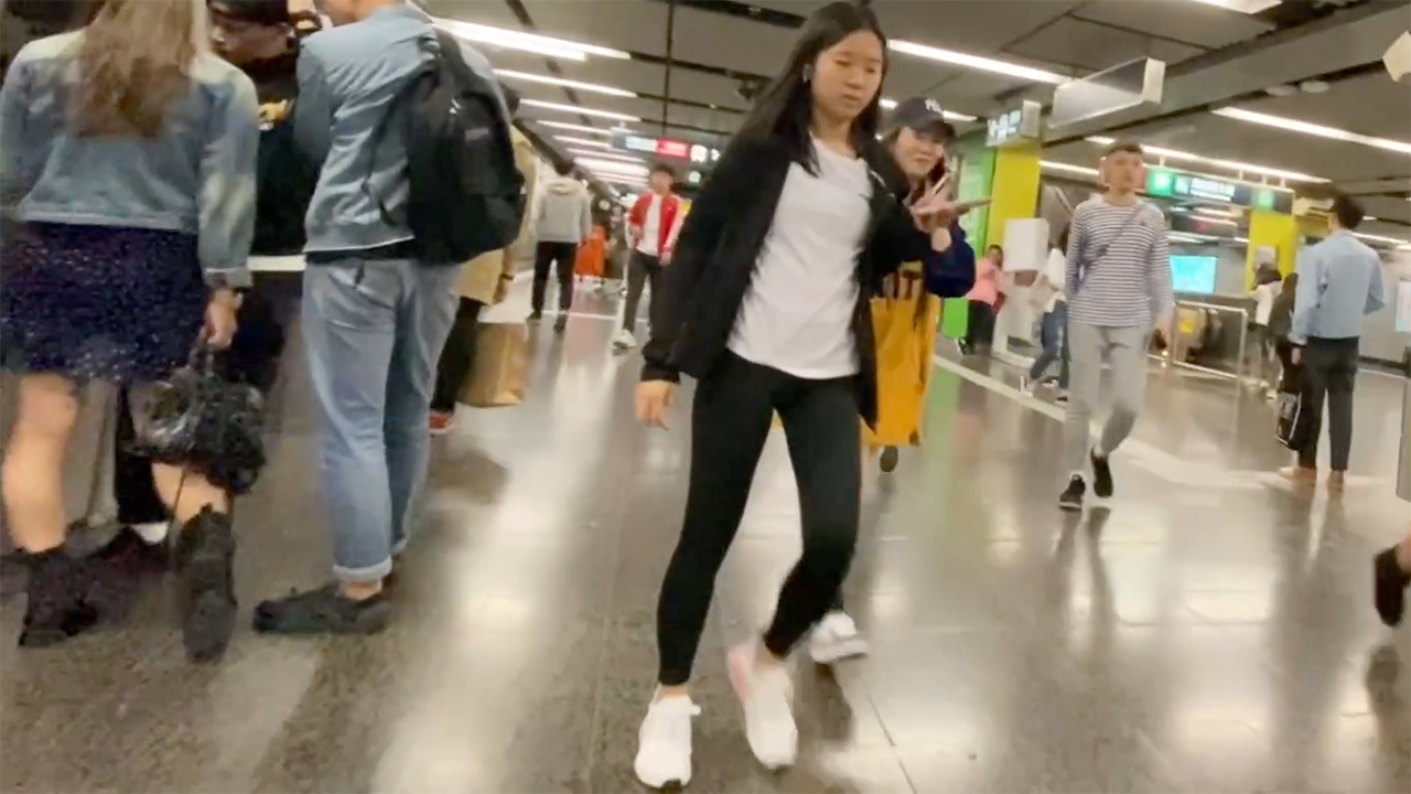 Cute Amateur Asian in leggings walking along MTR hallway