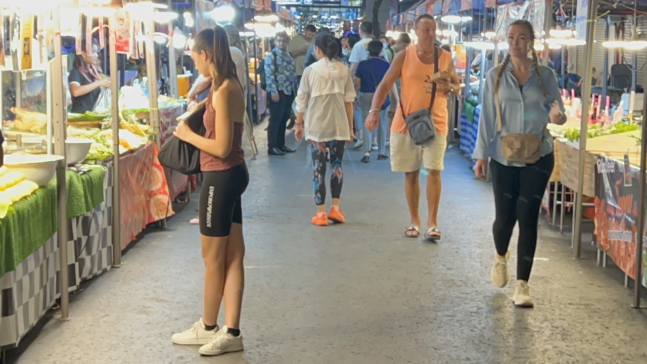 Hot girl standing at Patpong Market in spandex shorts