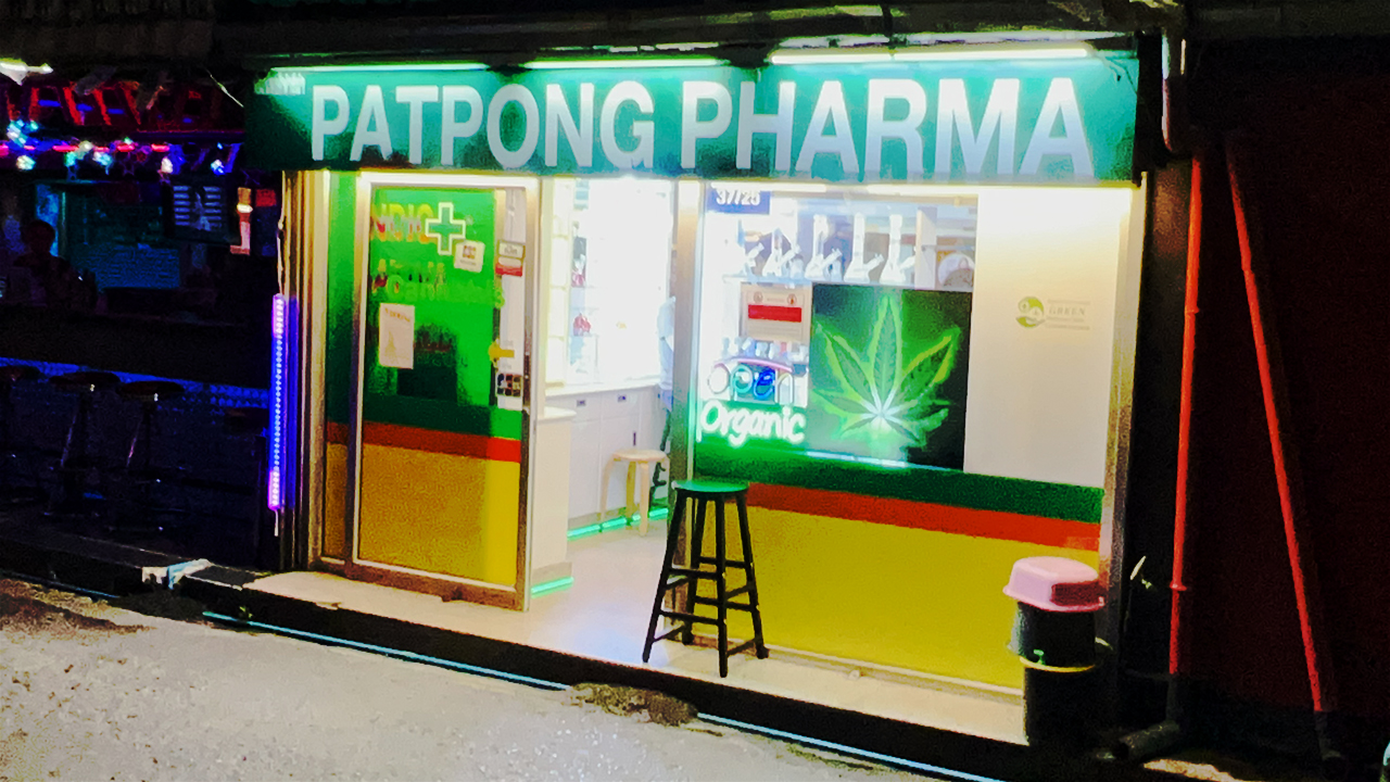 Patpoong Pharma store front at night with open door