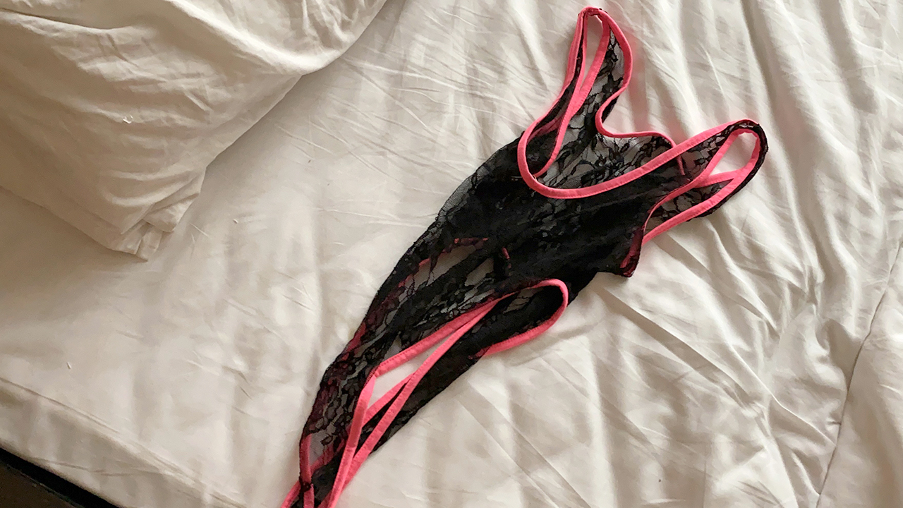 Pink and black see through lace Sexy Lingerie laying on bed