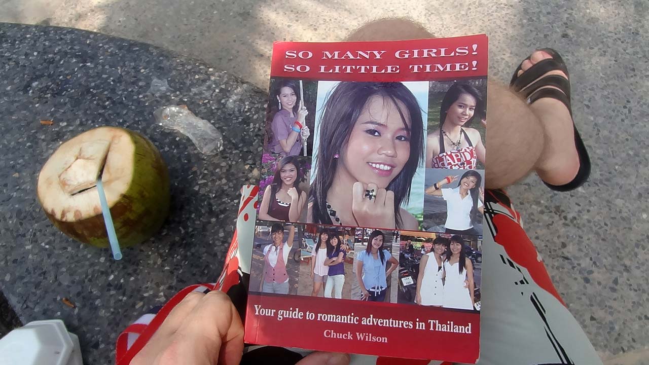 John holding copy of the book So Many Girls So Little Time