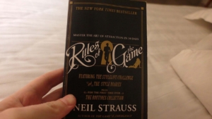 Rules Of The Game Neil Strauss book held in hand