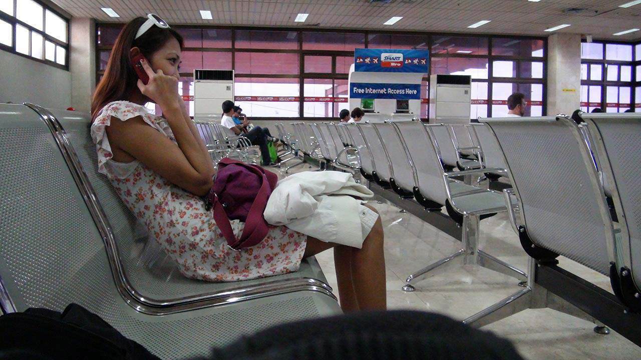Sexy Passenger in airport talking on phone