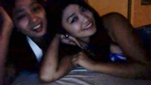 Smiling Filipina Hot Cam girls lay together