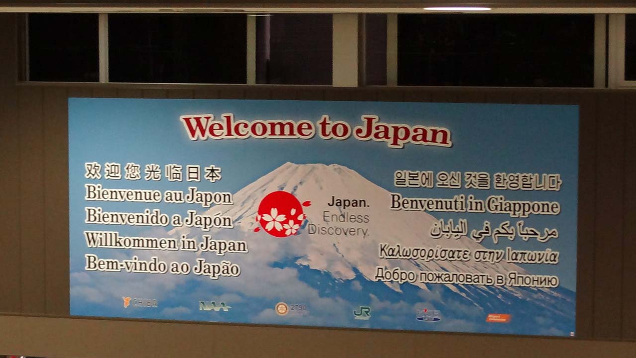 Welcome sign seen at airport after Flight To Japan