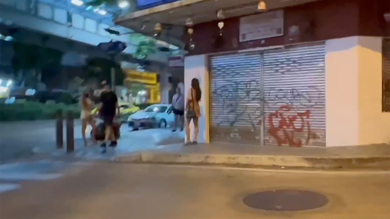 Thai Street Girls filmed from street while passing a corner