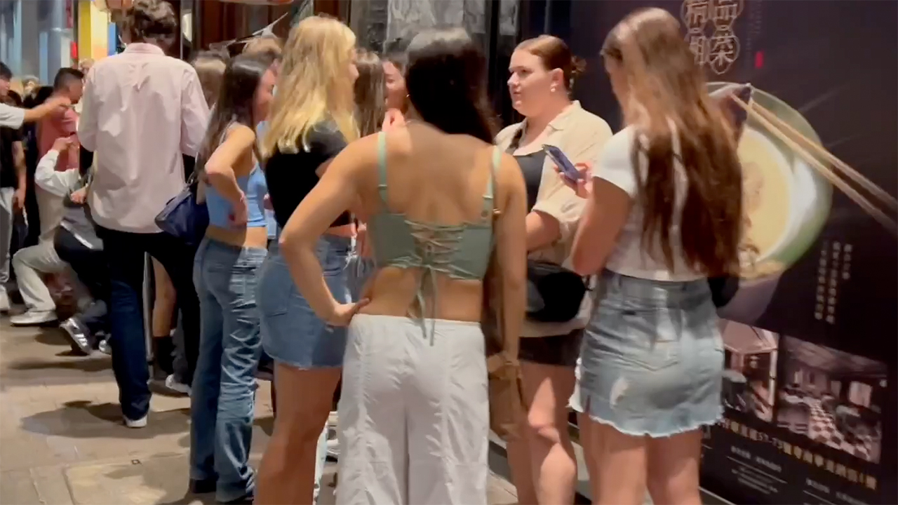 White Hong Kong Tourists girls standing on sidewalk
