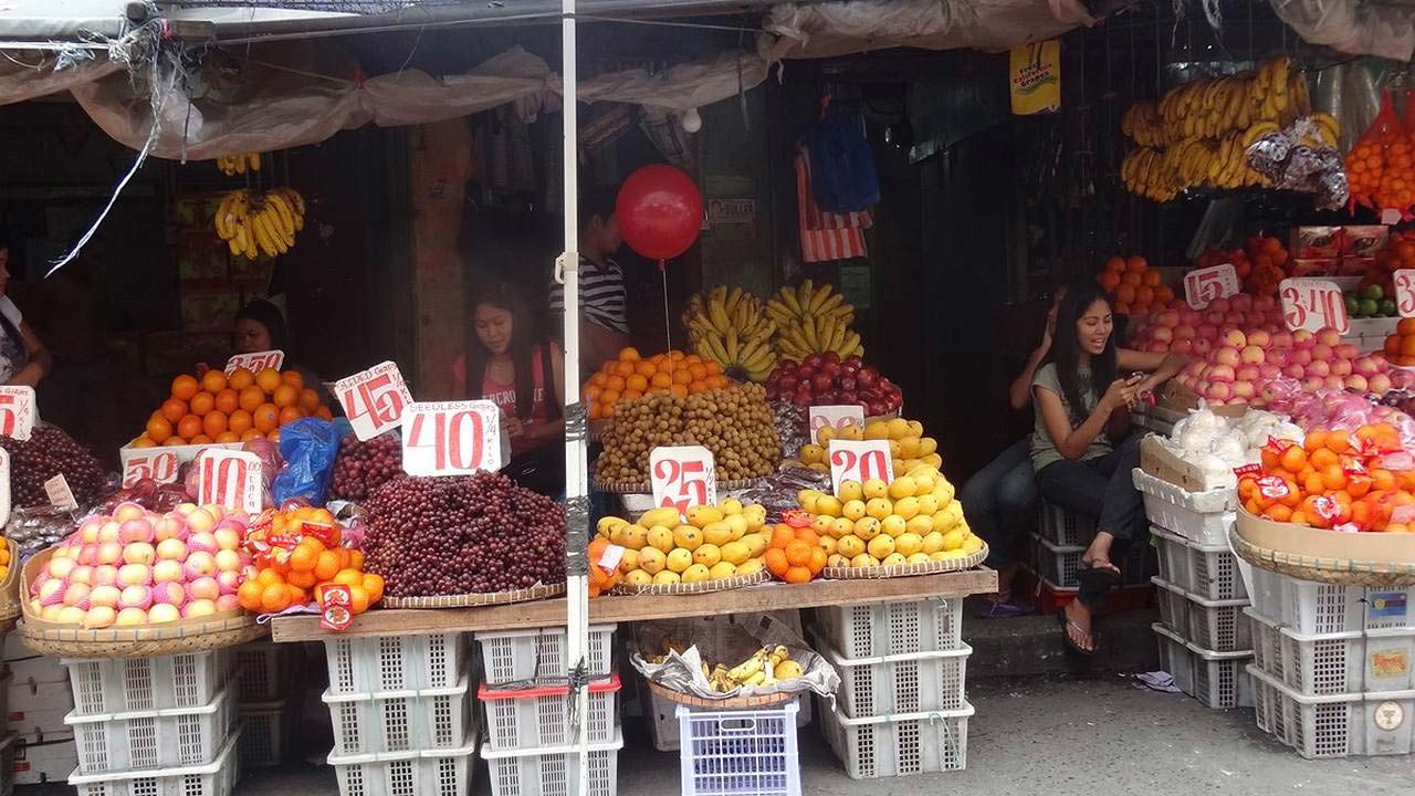 Filipina girls sitting inside Downtown Angeles City fruit store