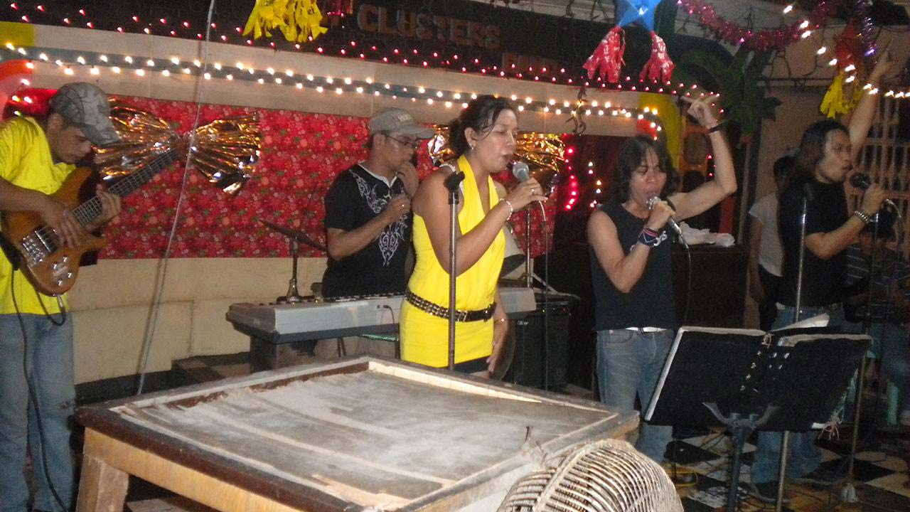 2 Filipinas Singing at club with terrible band